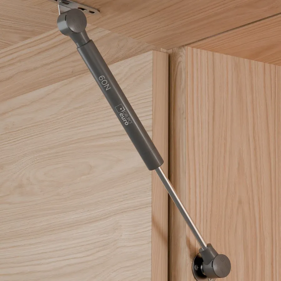 Pistón a gas montado entre el lateral y la puerta de una alacena de madera.